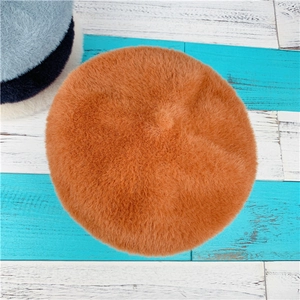 Detailed close-up of plush faux rabbit fur berets in caramel, blue, black and cream