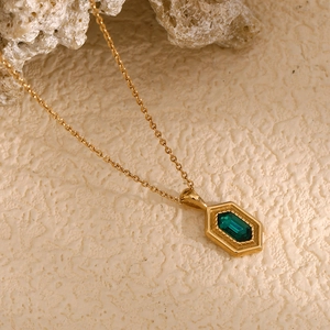 Detail of 18K gold-plated hexagonal pendant necklace with green rectangular gemstone