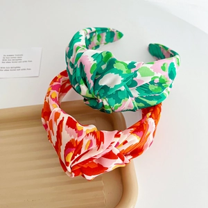 Detailed close-up of colorful floral knotted headbands showing fabric texture and design