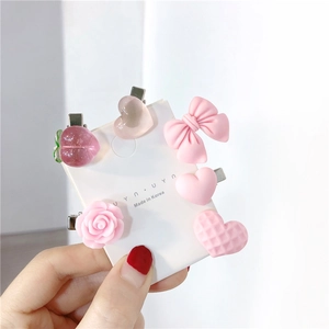 Pink sweet hair clip set with resin peaches, bows and heart-shaped clips on a display card