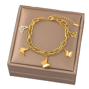 Double-layered gold titanium bracelet with butterfly charms and textured links on leather