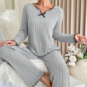 Women's grey ribbed pajama set with black lettuce trim and decorative bow accents