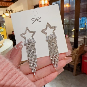 Detail of 925 silver needle star earrings with glittering tassel and rhinestone inlay