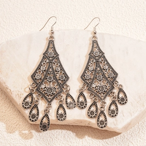 Vintage silver bohemian hollow floral earrings with teardrop tassels on white stone base