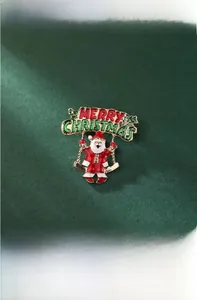 Macro view of Santa Claus on swing Christmas brooch with rhinestones and 4cm size