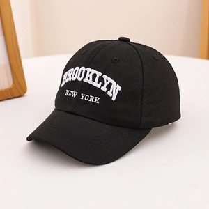 Close-up of white Brooklyn New York embroidery on black twill cotton baseball cap