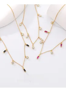 Detailed shot of gold geometric S925 necklace with colorful zircon stones on props