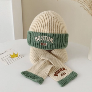 Detail of embroidered BOSTON 1630 logo on off-white and green knitted hat and scarf set