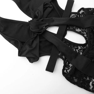 Detail of black lace stitching with criss-cross ties and bow on female jumpsuit