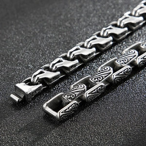 Detail of vintage silver titanium steel chain with engraved patterns and polished finish
