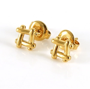 Detail of 18K gold stainless steel stud earrings with hollow grid four-leaf clover design