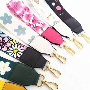 Wristlet straps with floral patterns and gold metal clasps on a clean white background