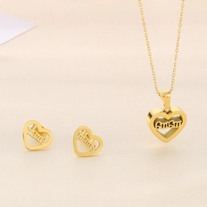 Macro view of gold-plated hollow heart necklace and earrings with mama text engraving