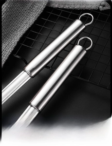Detail of stainless steel ice tongs with hollow anti-scald handle and hanging ring feature