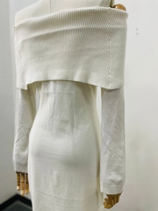 Close-up of white ribbed knit fabric texture on an elegant off-shoulder long-sleeve dress