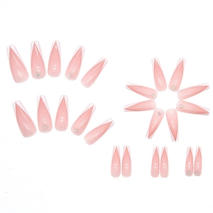Flat lay of pink long trapezoid press-on nails with white French tips and small rhinestones