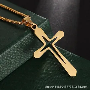 Macro shot of gold hollow cross pendant necklace on a dark green jewelry box