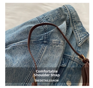 Close-up of adjustable dark brown leather shoulder strap with polished gold buckle