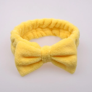 Soft yellow flannel headband with a large bow for face washing and makeup