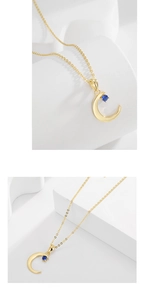 Detail of gold crescent moon necklace featuring a sparkling round blue gemstone pendant