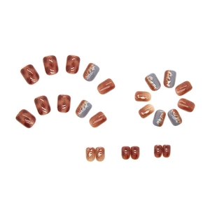 Press-on nails featuring amber tortoiseshell, blue-grey gold foil, and caramel gradients