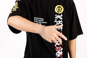 Close-up of a silver-tone chunky chain bracelet on wrist showing its minimalist punk design