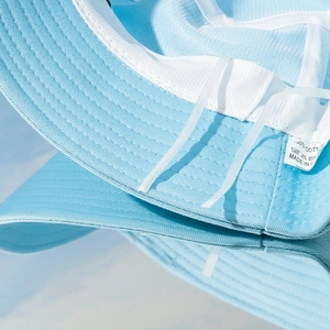 Detail of blue cotton sun hat featuring white mesh lining and adjustable drawstring