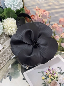 Close-up of leather floral tote bag with high-quality texture and metal bottom studs