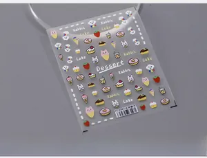 Macro shot of 5D self-adhesive nail stickers with cute rabbit and dessert designs