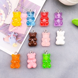 Close-up of 10 colorful resin gummy bear charms with silver loops for DIY jewelry making