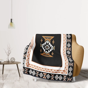 Ethnic geometric pattern flannel blanket draped over a modern armchair in a bright room