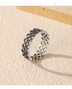 Macro view of vintage S925 sterling silver lace heart ring with oxidized milgrain details
