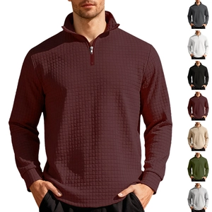 Close-up of men's quarter-zip sweatshirt showing 3D waffle knit texture and ribbed cuffs