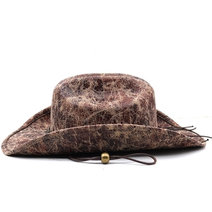 Detail of faux suede cowboy hat showing vintage brown texture and adjustable cord bead
