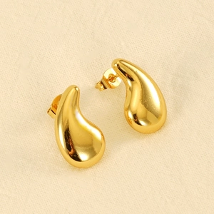 Polished 18K gold plated stainless steel teardrop earrings on beige fabric background