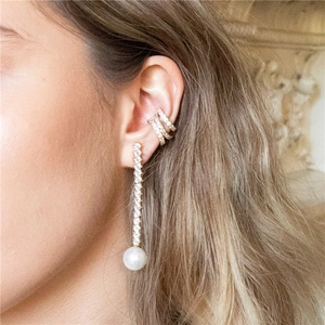 Detailed view of sterling silver long pearl drop earrings and sparkling ear cuff set