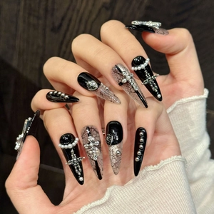 Gothic long stiletto press-on nails with black lace patterns and silver metal crosses