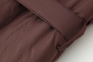 Macro shot of durable chocolate brown nylon fabric and precision double-stitched belt loop