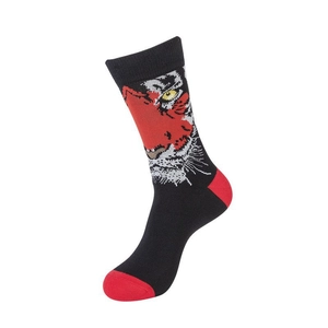 Close-up of creative knitted socks featuring a bold tiger pattern and red toe detail