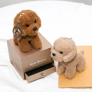 Close-up of cute curly teddy dog plush keychains in dark brown and light beige colors