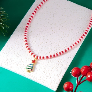 Close-up of beaded Christmas necklace featuring a golden tree pendant and festive elements
