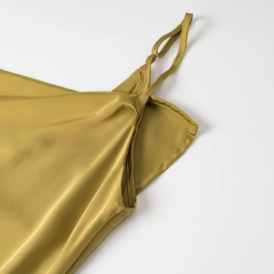 Detail of adjustable metallic straps and premium olive satin fabric on silk dress