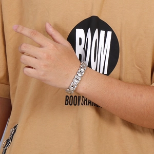 Close-up of heavy industrial style stainless steel chain bracelet on male model wrist