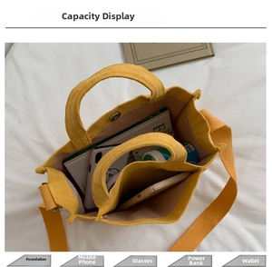 Internal layout of yellow corduroy handbag showing dual compartments and storage capacity