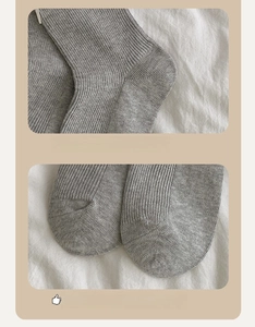 Detail view of grey knit socks featuring reinforced 3D heel and smooth flat toe seams