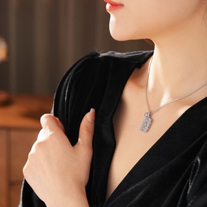 Detailed view of silver zircon hollow square pendant necklace worn on a neck