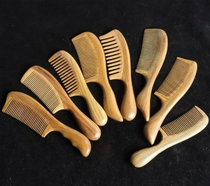 Detailed overhead view of assorted natural sandalwood hair combs with various tooth widths