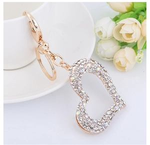 Close-up of heart-shaped gold keychain with sparkling rhinestones and elegant details