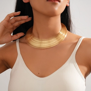 Close-up of chunky gold layered metallic neck choker on model with smooth finish