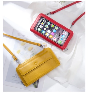 Detail view of red and yellow touchscreen phone purses with transparent windows and PU leather